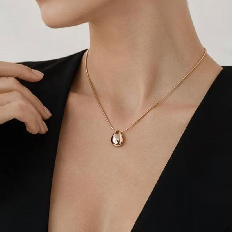 Model wearing an Aqua sculptural drop necklace