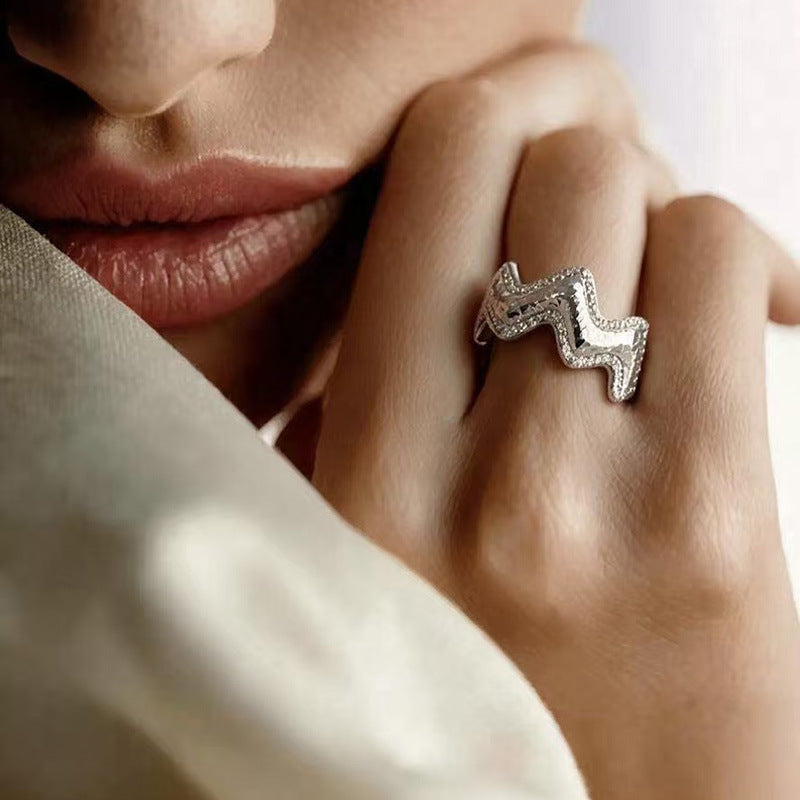 Vela sculptural wave ring in sterling silver with pavé zircon details