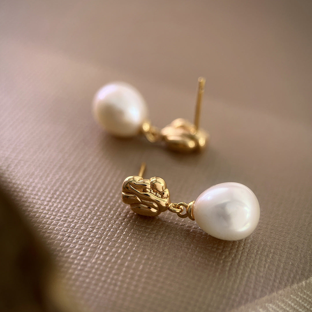 Sculptural gold-plated earrings with natural freshwater pearl drops