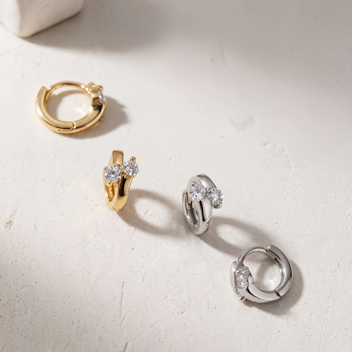 Lumi double CZ huggie earrings in gold and silver finishes