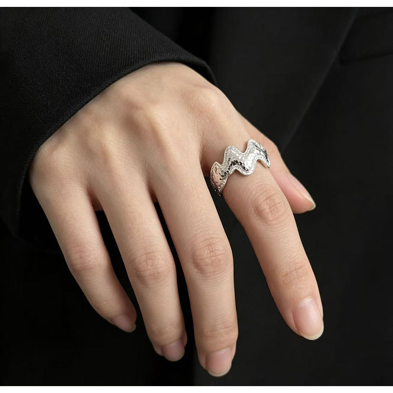 Close-up of Vela silver wave ring with pavé zircon accents