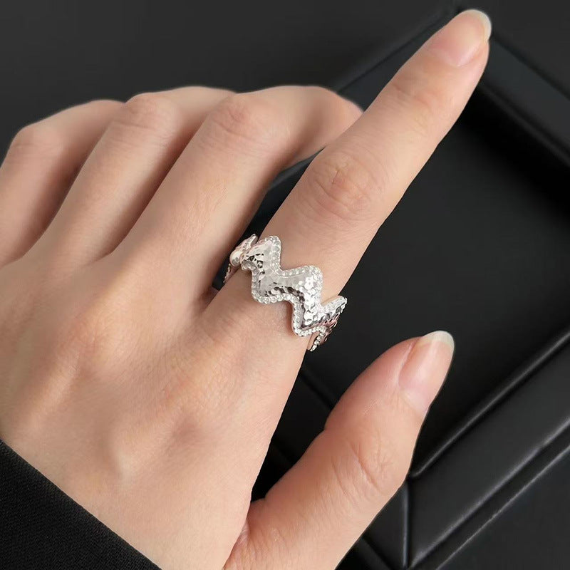 Close-up of Vela silver wave ring with pavé zircon accents