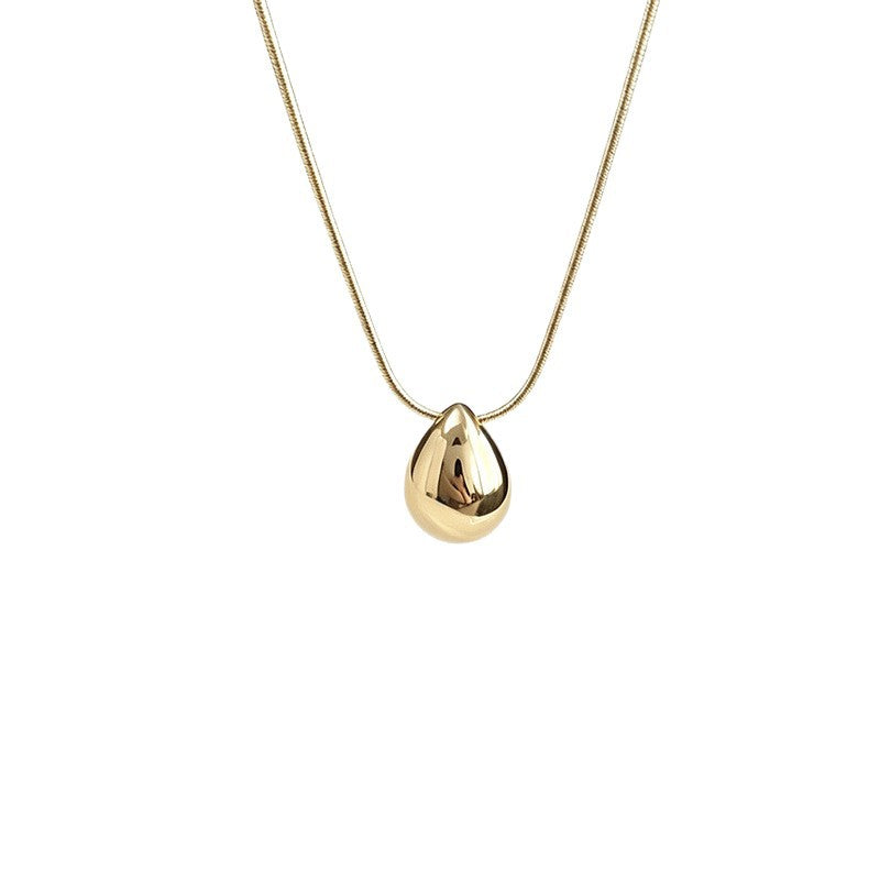 Aqua sculptural drop necklace on a white background