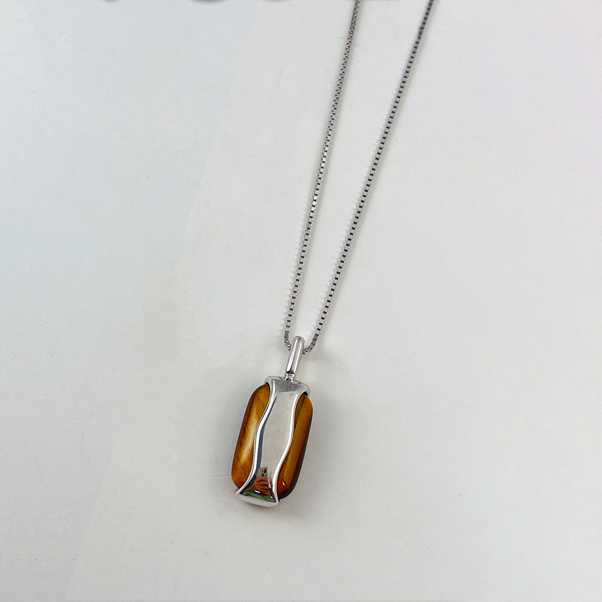 Sola tiger’s eye pendant necklace in gold and silver finishes