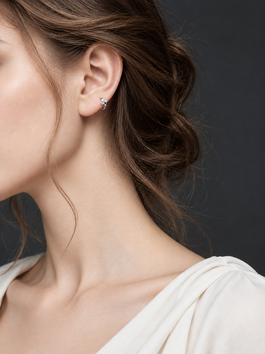 Model wearing a silver Lumi double CZ huggie earring