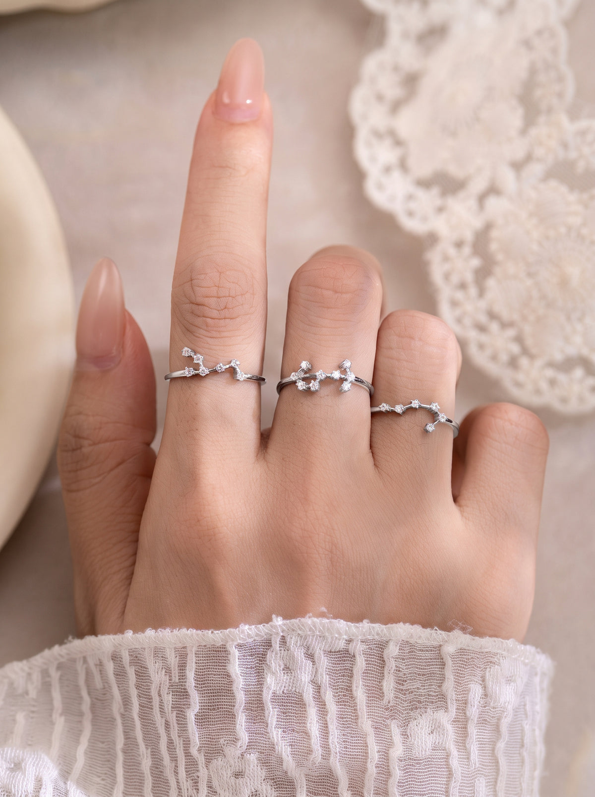 Celeste zodiac sterling silver rings worn on a hand
