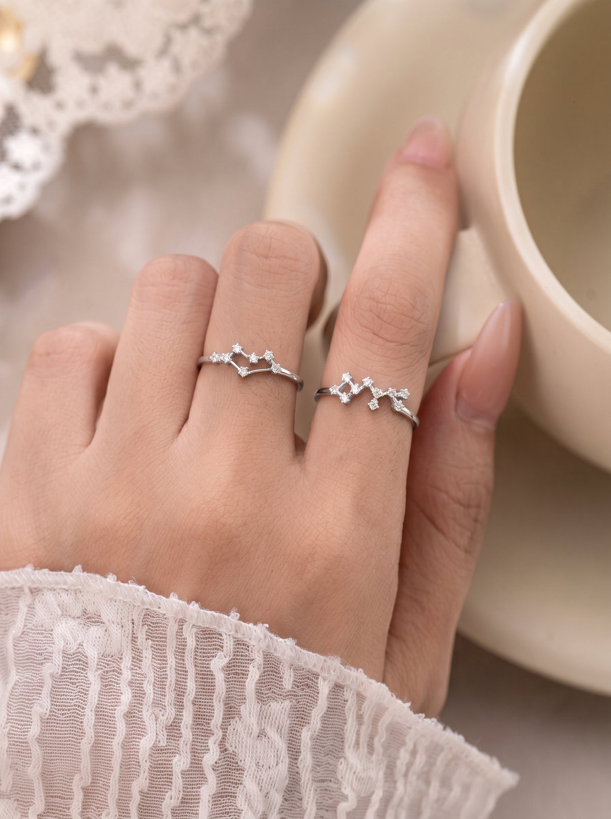 Celeste zodiac sterling silver rings worn on a hand