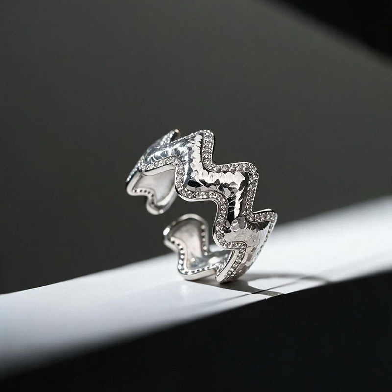 Close-up of Vela silver wave ring with pavé zircon accents