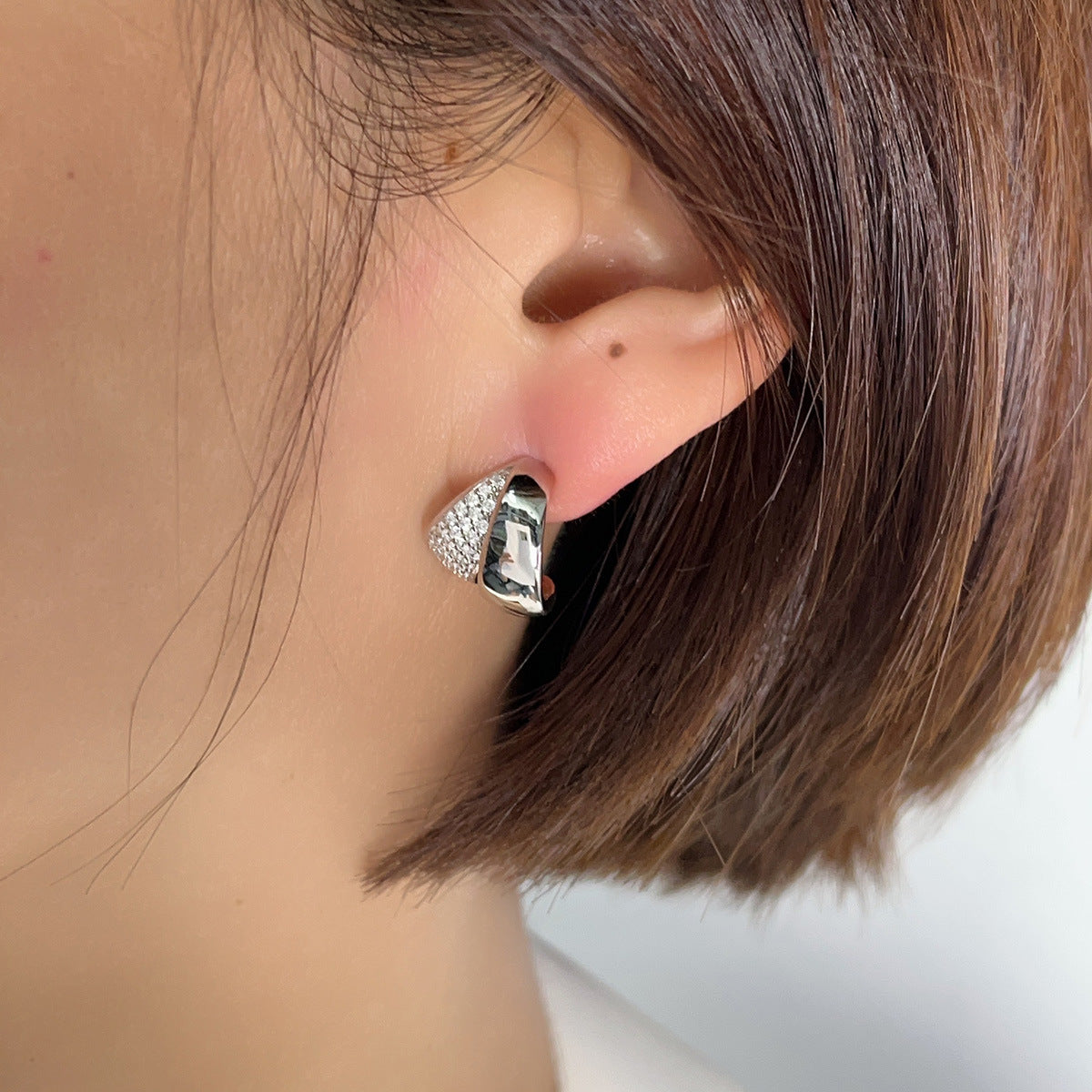 Polished sterling silver stud earrings with pavé zircon detailing